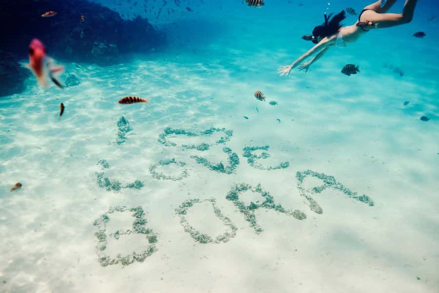 Bora Bora: Lagoon Tour and Snorkeling Experience - Boarding the motorized outrigger